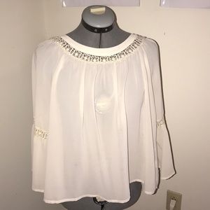 Boho crochet swing shirt with trumpet sleeves.